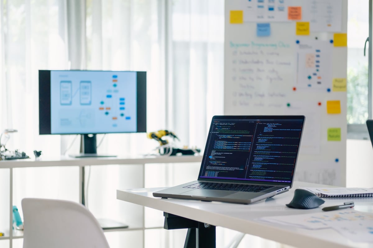 Programmer coding a website interface at a modern developer workspace